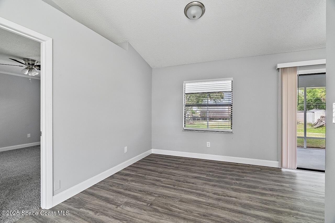 914 Devon Avenue Sebastian, FL 32958 - Photo 16 of 40 wooden floor in an empty room with a window