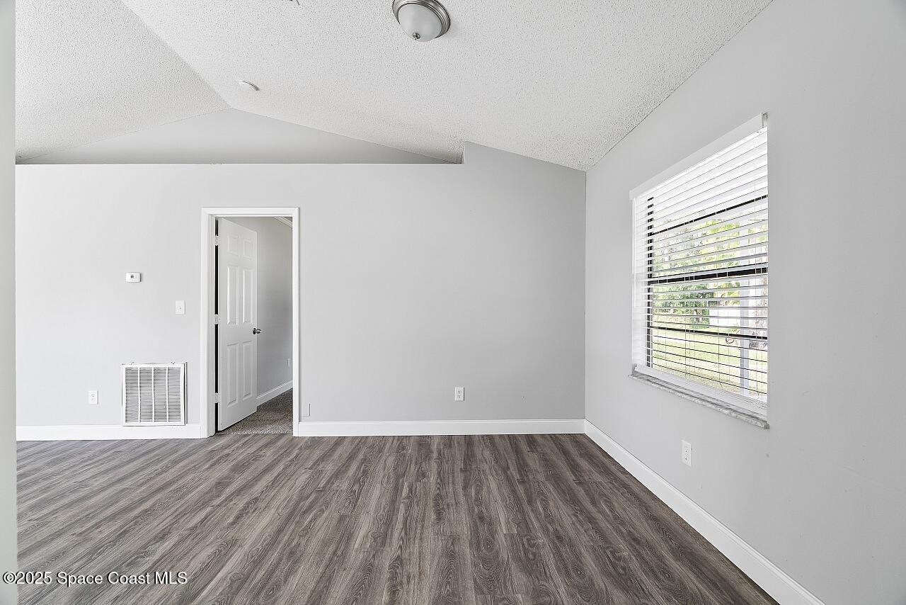 914 Devon Avenue Sebastian, FL 32958 - Photo 17 of 40 an empty room with wooden floor and windows
