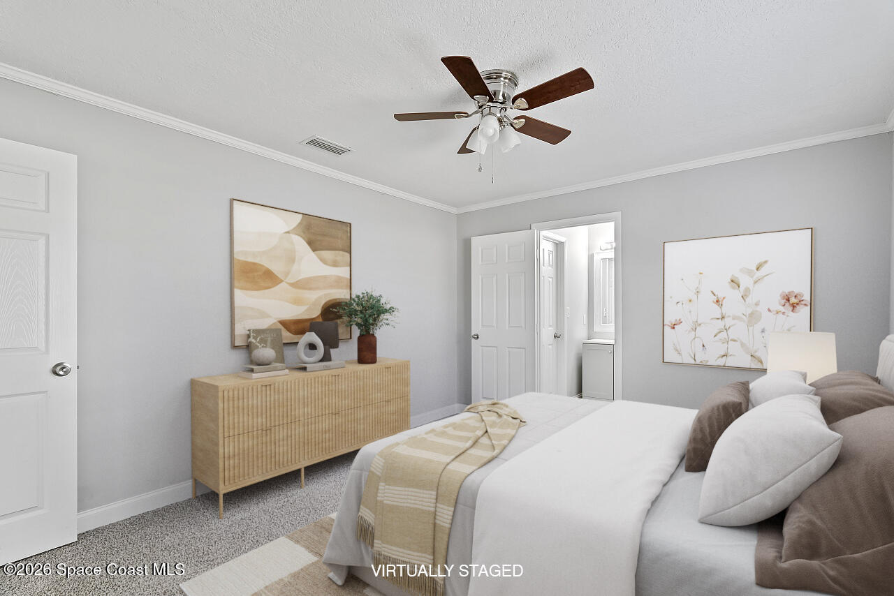 914 Devon Avenue Sebastian, FL 32958 - Photo 21 of 40 a bedroom with a large bed and a painting on the wall