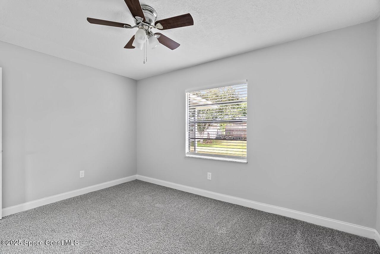 914 Devon Avenue Sebastian, FL 32958 - Photo 30 of 40 an empty room with windows and fan