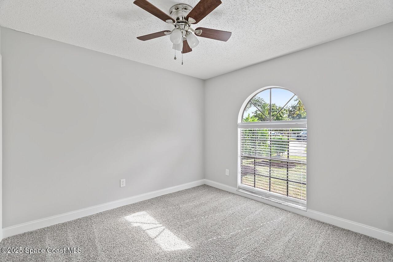 914 Devon Avenue Sebastian, FL 32958 - Photo 33 of 40 an empty room with windows and ceiling fan