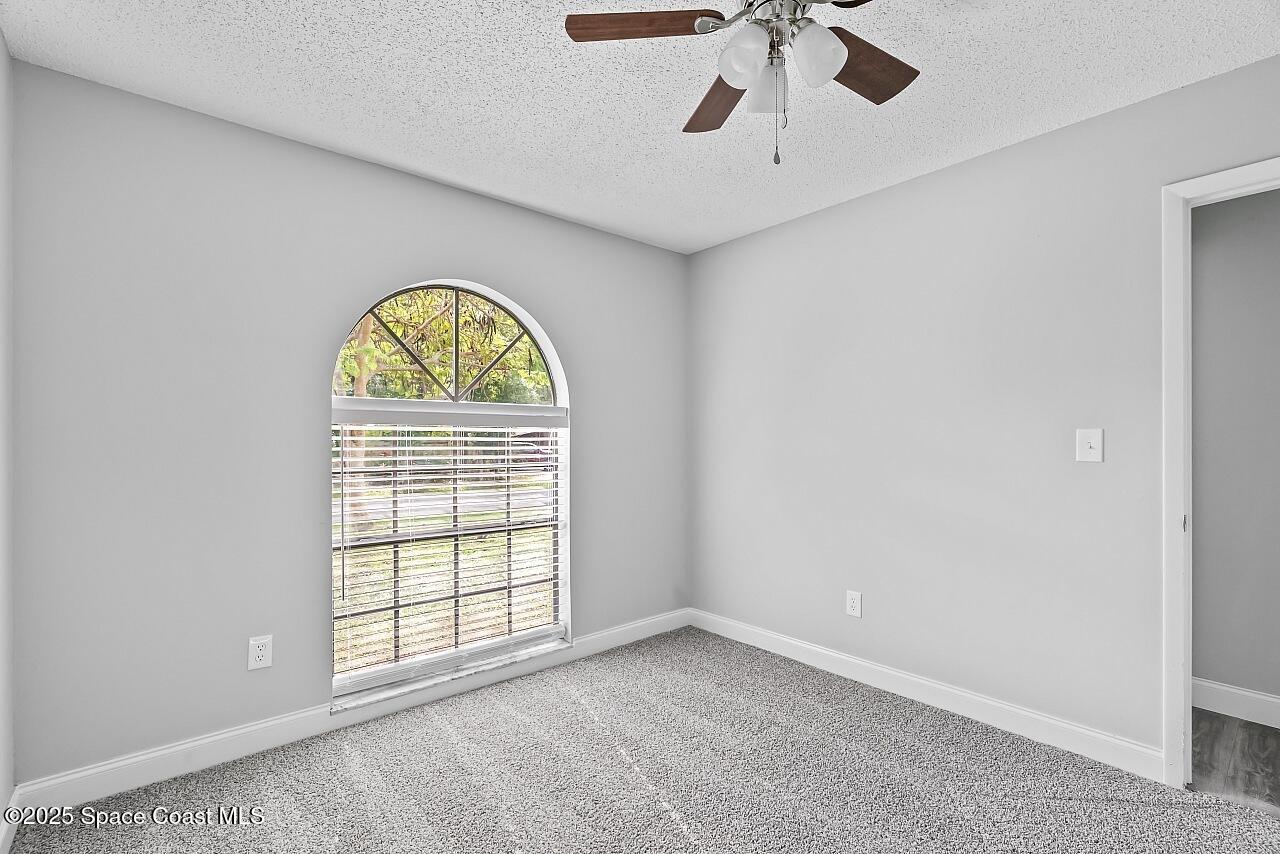 914 Devon Avenue Sebastian, FL 32958 - Photo 34 of 40 an empty room with a window and a chandelier