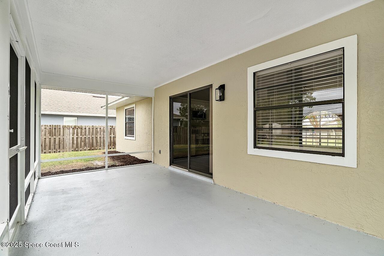 914 Devon Avenue Sebastian, FL 32958 - Photo 36 of 40 a view of an empty room with a fireplace and a large window