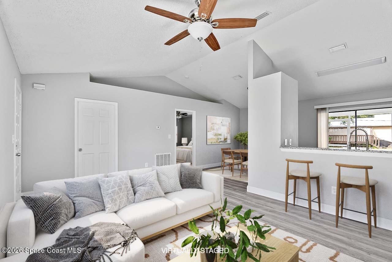 914 Devon Avenue Sebastian, FL 32958 - Photo 7 of 40 a living room with furniture a ceiling fan and a window