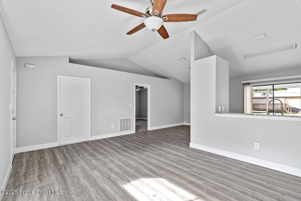 914 Devon Avenue Sebastian, FL 32958 - Photo 8 of 40 a view of empty room with wooden floor and fan