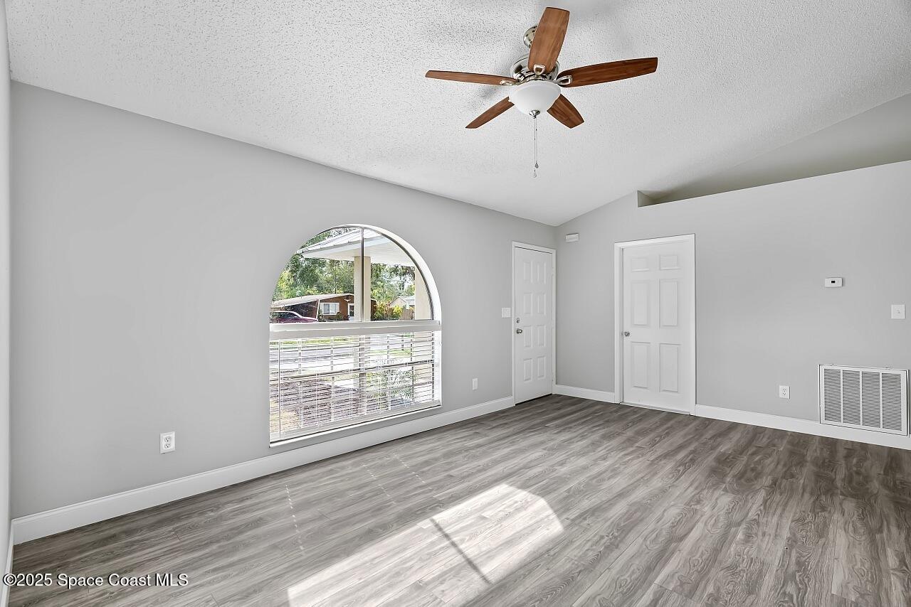 914 Devon Avenue Sebastian, FL 32958 - Photo 9 of 40 wooden floor in an empty room with a window
