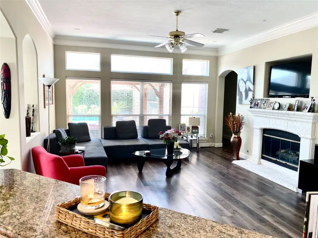 a living room with furniture fireplace and flat screen tv
