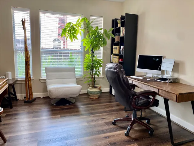 a workspace with furniture hardwood and a window