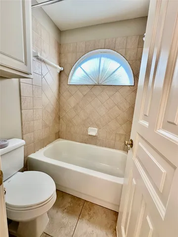 a bathroom with a toilet and a tub
