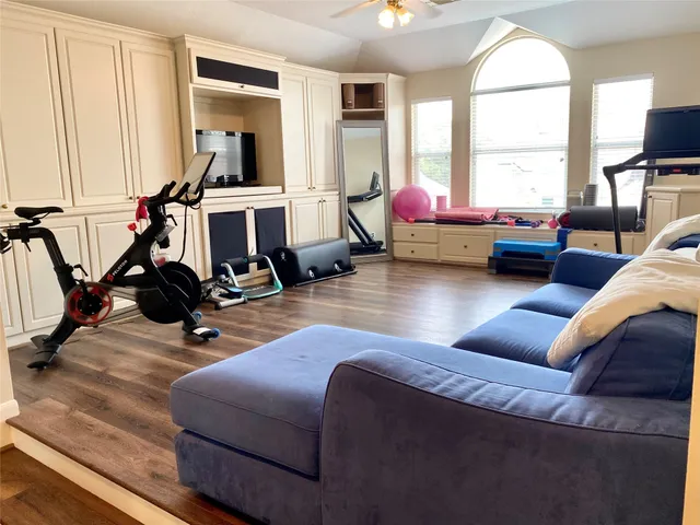 a room with gym equipment and a large window