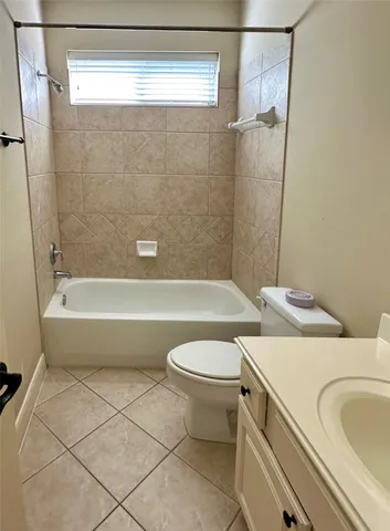 a bathroom with a toilet a sink and bathtub