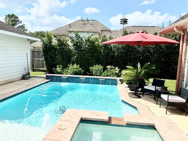 a view of a house with swimming pool and sitting area