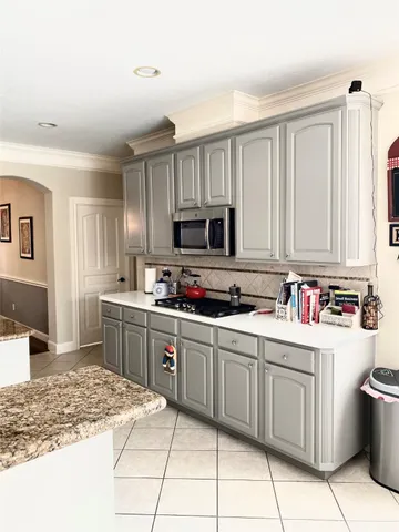 a kitchen with a sink cabinets and appliances
