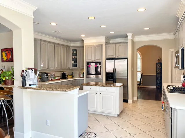 a kitchen with stainless steel appliances granite countertop a sink and cabinets