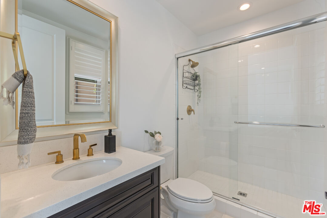 11734 Manchester Way Porter Ranch, CA 91326 - Photo 12 of 35 a bathroom with a sink a toilet and shower