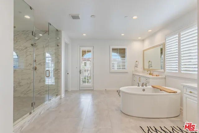 a bathroom with a bathtub and shower
