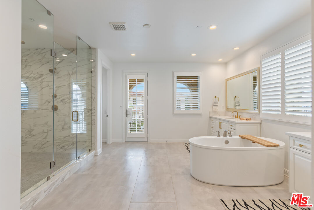 11734 Manchester Way Porter Ranch, CA 91326 - Photo 17 of 35 a bathroom with a bathtub and shower