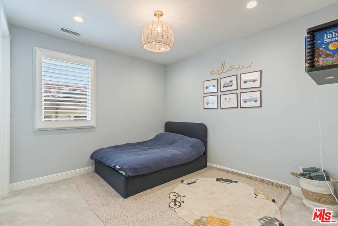 11734 Manchester Way Porter Ranch, CA 91326 - Photo 22 of 35 a bedroom with a bed and a table in it