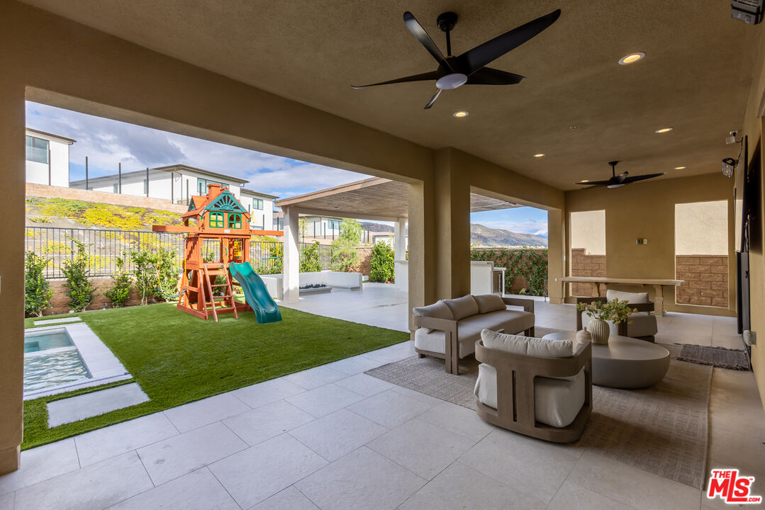 11734 Manchester Way Porter Ranch, CA 91326 - Photo 24 of 35 a living room with patio furniture and a garden