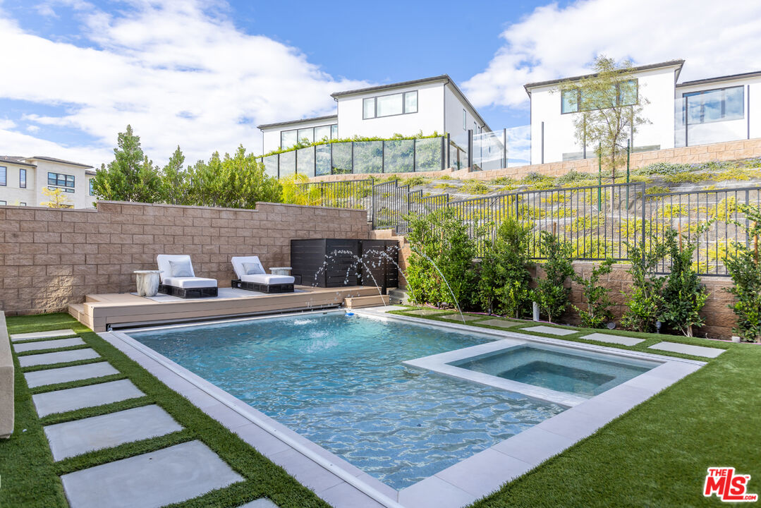 11734 Manchester Way Porter Ranch, CA 91326 - Photo 25 of 35 a view of a swimming pool with a patio