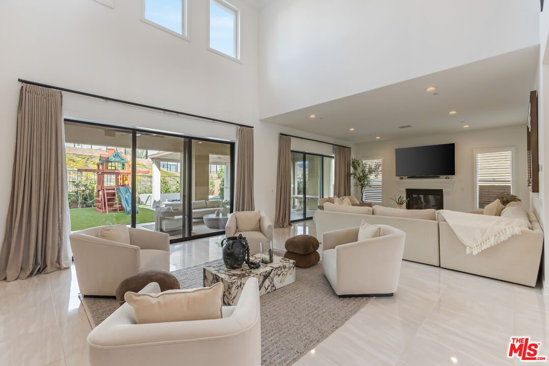 11734 Manchester Way Porter Ranch, CA 91326 - Photo 3 of 35 a living room with furniture and a flat screen tv