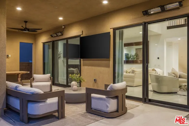 a living room with furniture and a glass door