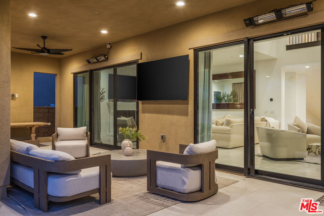 11734 Manchester Way Porter Ranch, CA 91326 - Photo 33 of 35 a living room with furniture and a glass door