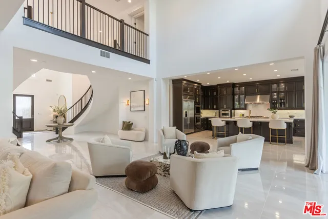 a living room with furniture a mirror and a potted plant