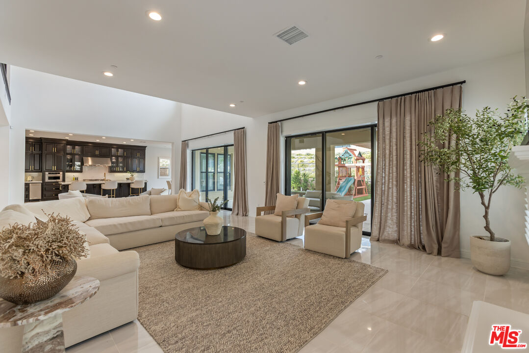 11734 Manchester Way Porter Ranch, CA 91326 - Photo 7 of 35 a living room with furniture and a potted plant
