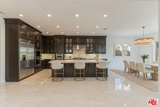 a large kitchen with a table and chairs