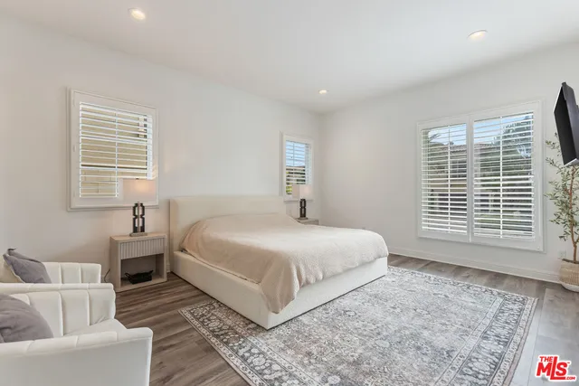 a bedroom with a large bed and a couch