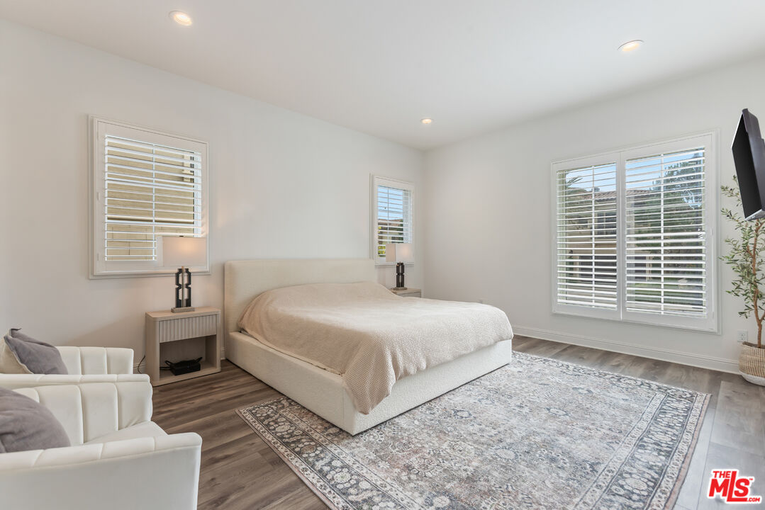 11734 Manchester Way Porter Ranch, CA 91326 - Photo 10 of 35 a bedroom with a large bed and a couch