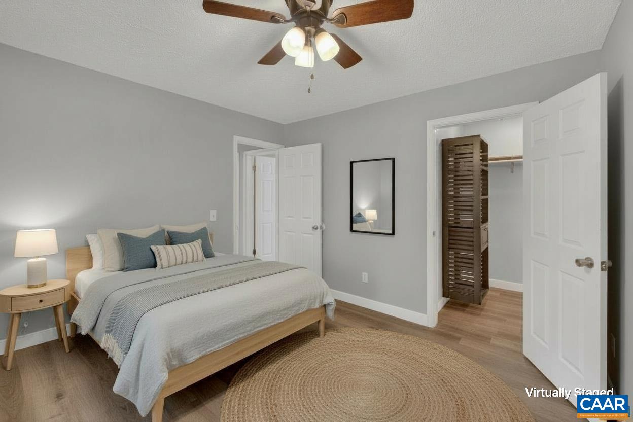 673 Cedar Lane Road Palmyra, VA 22963 - Photo 22 of 47 a bedroom with a bed and a chandelier