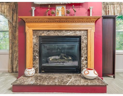 16 Rolling Hill Road Billerica, MA 01821 - Photo 10 of 27 a living room with a fireplace windows and a fireplace