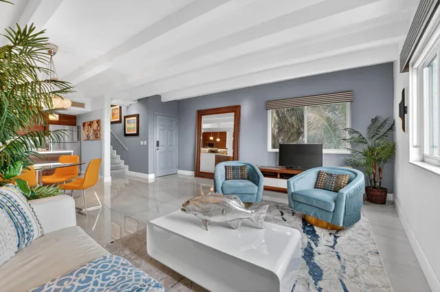 a living room with furniture and a potted plant