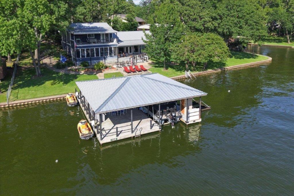 a aerial view of a house with swimming pool table and chairs