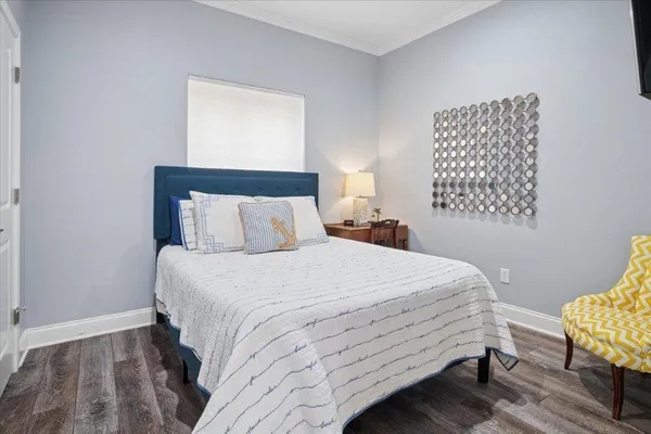 a bedroom with a bed two lamps and a window