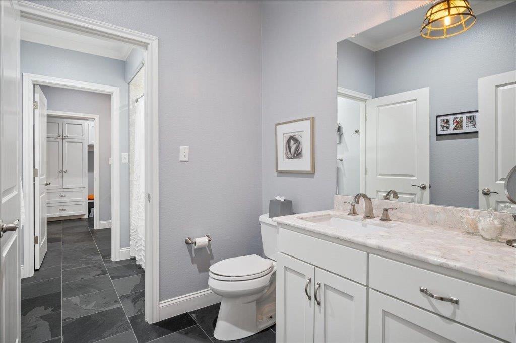 154 Bayside Circle Malakoff, TX 75148 - Photo 27 of 40 a bathroom with a granite countertop sink a toilet and a mirror