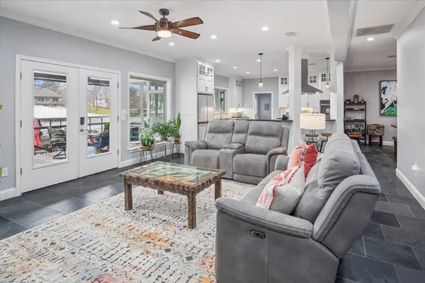 a living room with furniture and kitchen view