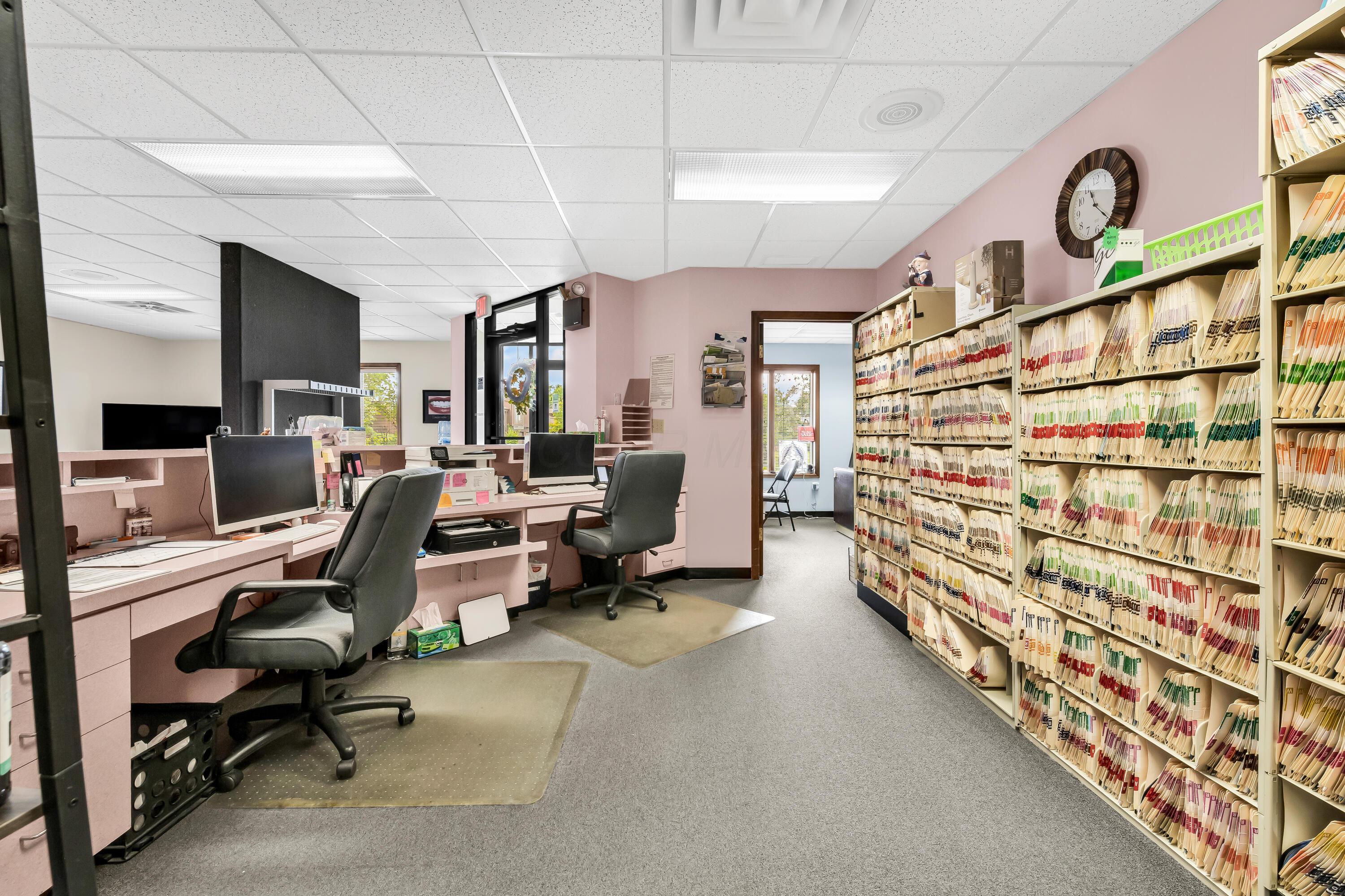 1240 Crescent Heights Road Marion, OH 43302 - Photo 17 of 60 • Blue carpet • Pink painted walls • Acoustic ceiling tiles • Fluorescent lighting • Receptionist counter