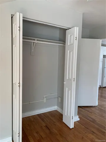 a view of water heater room with wooden floor