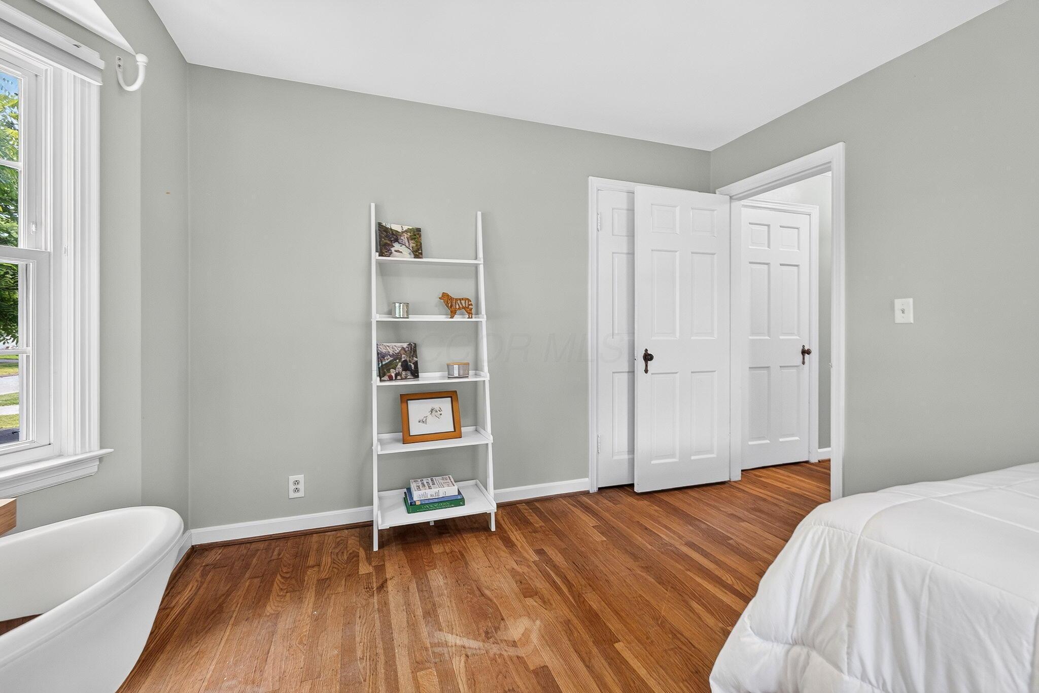 492 Wetmore Road Columbus, OH 43214 - Photo 31 of 55 Hardwood flooring present in this room features a light grey wall color, white trim, and a white six-panel door
