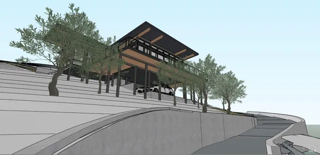 a view of a street with house and trees in the background