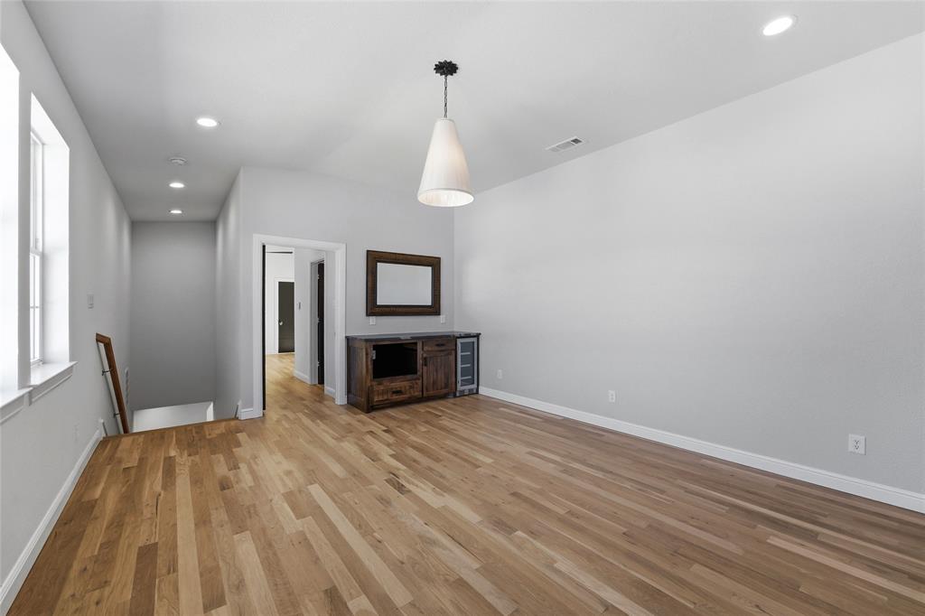 623 Lake Valley Road Sunset, TX 76270 - Photo 24 of 40 a view of empty room with wooden floor and fan