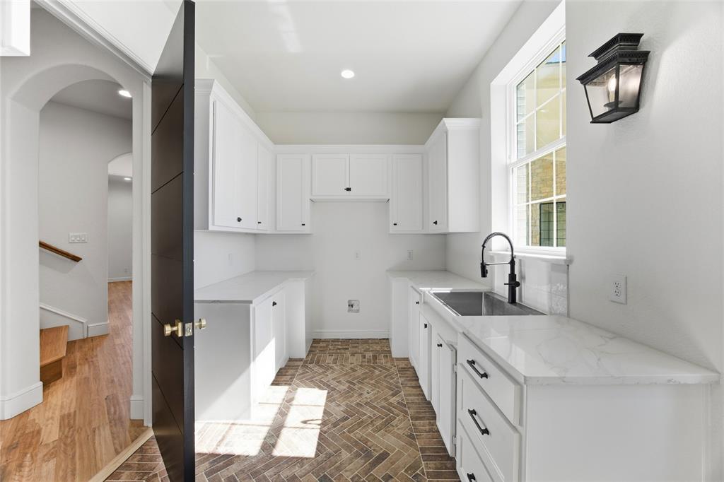 623 Lake Valley Road Sunset, TX 76270 - Photo 26 of 40 a large white kitchen with a sink a refrigerator and window