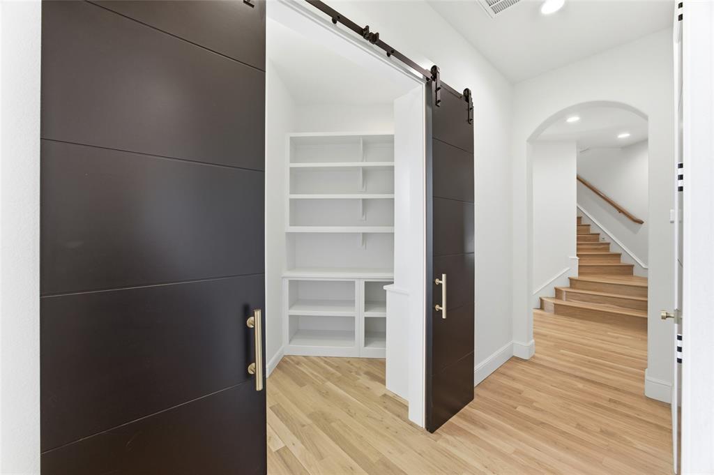 623 Lake Valley Road Sunset, TX 76270 - Photo 29 of 40 a view of a hallway with wooden floor and staircase