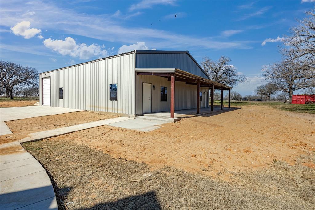 623 Lake Valley Road Sunset, TX 76270 - Photo 34 of 40 a view of a house with a yard