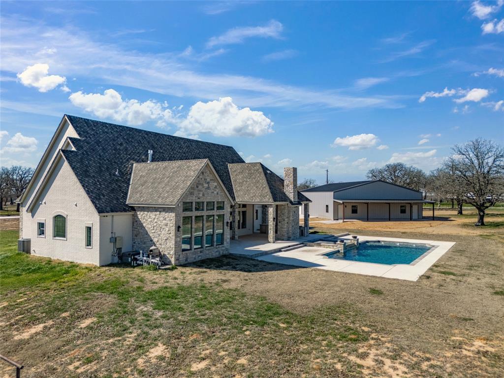 623 Lake Valley Road Sunset, TX 76270 - Photo 36 of 40 a front view of a house with garden
