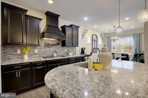a kitchen with a sink appliances and cabinets