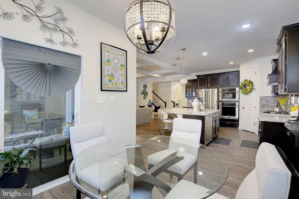 a living room with fireplace furniture and a chandelier